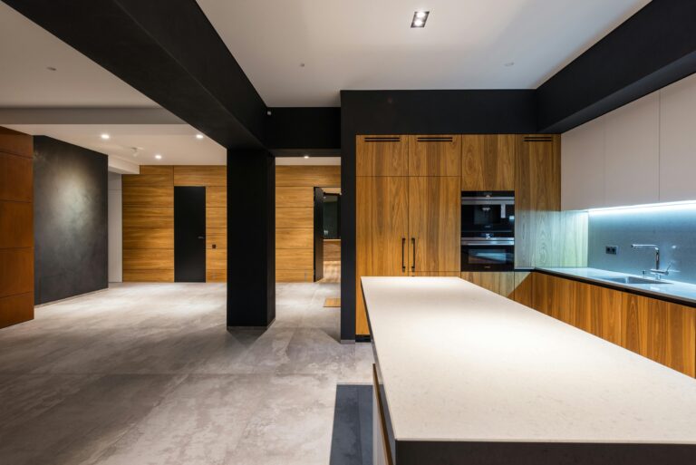 Sleek contemporary kitchen interior with wooden cabinets and minimalist style.